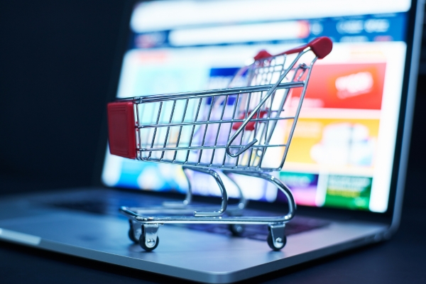 E-commerce website with small shopping trolley in front